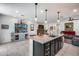 Open concept kitchen with large island, dark cabinetry, and granite countertops at 4707 S Avitus Ln, Mesa, AZ 85212