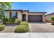 Single story home with a two car garage and landscaped yard at 4707 S Avitus Ln, Mesa, AZ 85212