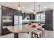 Spacious kitchen with dark cabinets, granite counters, and an island at 4707 S Avitus Ln, Mesa, AZ 85212