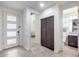 Bright entryway with tile flooring, modern door, and built-in storage at 4707 S Avitus Ln, Mesa, AZ 85212