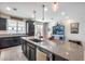 Modern kitchen with dark cabinetry, granite island, and pendant lighting at 4707 S Avitus Ln, Mesa, AZ 85212