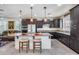 Kitchen with dark cabinets, granite island, and stainless steel appliances at 4707 S Avitus Ln, Mesa, AZ 85212