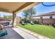 Backyard with covered patio, artificial turf, and grill at 4707 S Avitus Ln, Mesa, AZ 85212