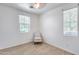 Well-lit bedroom with two windows and a comfy chair at 4707 S Avitus Ln, Mesa, AZ 85212