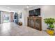 Living room with tiled floors, a large TV, and a display cabinet at 4707 S Avitus Ln, Mesa, AZ 85212