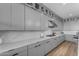 Sleek kitchen with gray cabinets, marble countertops, and stainless steel appliances at 3902 W Ruby Way, Queen Creek, AZ 85142