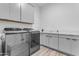 Laundry room with modern washer, dryer, and cabinets at 3902 W Ruby Way, Queen Creek, AZ 85142