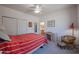 Bedroom with red striped bedding and ceiling fan at 1880 W Roderick Ln, Wickenburg, AZ 85390