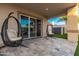 Relaxing patio with hanging chairs and view of backyard at 6827 E Ivyglen St, Mesa, AZ 85207