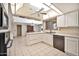 Spacious kitchen boasts a large island, updated appliances, and a view to the dining area at 12807 W Mesa Verde Dr, Sun City West, AZ 85375