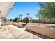 View of backyard with patio and mature trees at 12807 W Mesa Verde Dr, Sun City West, AZ 85375