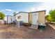 Mobile home exterior with small patio and landscaping at 201 S Greenfield Rd # 216, Mesa, AZ 85206