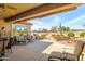 Extended covered patio with multiple seating areas and grill at 18364 N Diamond Dr, Surprise, AZ 85374