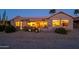 Evening view of backyard, showing home's exterior and landscaping at 18364 N Diamond Dr, Surprise, AZ 85374