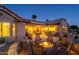 Backyard patio with fire pit and seating area at night at 18364 N Diamond Dr, Surprise, AZ 85374