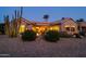 Landscaped backyard with fire pit and desert plants at dusk at 18364 N Diamond Dr, Surprise, AZ 85374
