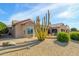 Desert landscaping with cactus and gravel surrounds this home's backyard at 18364 N Diamond Dr, Surprise, AZ 85374