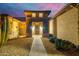 Front entry with stone accents and desert landscaping at night at 18364 N Diamond Dr, Surprise, AZ 85374