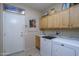 Convenient laundry room with washer, dryer, and extra cabinets at 18364 N Diamond Dr, Surprise, AZ 85374