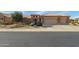 Single-story home with desert landscaping and a three-car garage at 18364 N Diamond Dr, Surprise, AZ 85374