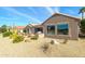 Home's backyard features a patio, grill, and desert landscaping at 18364 N Diamond Dr, Surprise, AZ 85374