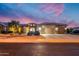 Stunning curb appeal with desert landscaping at dusk at 18364 N Diamond Dr, Surprise, AZ 85374