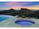 Round spa with purple lighting on a patio overlooking city lights at 11142 N Viento Ct, Fountain Hills, AZ 85268