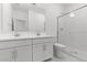 Modern bathroom with double vanity, shower, and white tile at 7862 N 80Th Ave, Glendale, AZ 85303