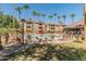 Relaxing pool area with lounge chairs and palm trees at 14950 W Mountain View Blvd # 1208, Surprise, AZ 85374