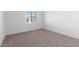 Bright bedroom with carpeted floor and window with blinds at 37735 W Padilla St, Maricopa, AZ 85138