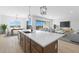 Open concept kitchen with island, modern cabinetry, and stainless steel appliances at 37735 W Padilla St, Maricopa, AZ 85138