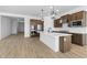 Modern kitchen with island, stainless steel appliances, and dark wood cabinets at 37735 W Padilla St, Maricopa, AZ 85138