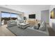Spacious living area featuring large windows and a modern aesthetic at 37735 W Padilla St, Maricopa, AZ 85138