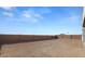 Backyard view with block wall and open desert landscape at 37735 W Padilla St, Maricopa, AZ 85138