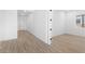 Bright hallway with light wood flooring and access to bedrooms at 37735 W Padilla St, Maricopa, AZ 85138