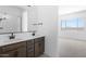 Double vanity bathroom with patterned floor at 37735 W Padilla St, Maricopa, AZ 85138