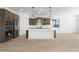 Modern kitchen with island, stainless steel appliances, and dark wood cabinets at 37735 W Padilla St, Maricopa, AZ 85138