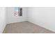 Simple bedroom with carpeted floor and window with blinds at 37735 W Padilla St, Maricopa, AZ 85138