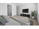 Main bedroom with king-size bed and large TV at 37735 W Padilla St, Maricopa, AZ 85138
