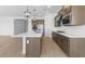 Modern kitchen with island, stainless steel appliances, and dark wood cabinets at 37735 W Padilla St, Maricopa, AZ 85138