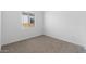 Cozy carpeted bedroom with a window offering natural light at 37735 W Padilla St, Maricopa, AZ 85138