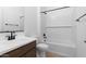 Bathroom with tub, vanity, and dark brown cabinets at 37735 W Padilla St, Maricopa, AZ 85138