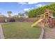 Large backyard with grassy area, playground, and grill at 406 E Glenhaven Dr, Phoenix, AZ 85048