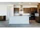 Modern kitchen featuring dark wood cabinets, white countertops, and a large island at 32663 N Aris Dr, San Tan Valley, AZ 85143