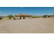 Tan house exterior with a gravel driveway and desert landscape at 44025 N Us Hwy 60 --, Morristown, AZ 85342