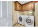 Laundry room with washer, dryer, and ample cabinet space at 27211 N 111 St, Scottsdale, AZ 85262