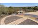 Ground-level sundial with a mosaic design and park bench at 12794 W Burnside Trl, Peoria, AZ 85383