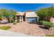 Modern home exterior with stone and glass accents at 12794 W Burnside Trl, Peoria, AZ 85383