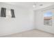 Simple bedroom with large window and carpeted floor at 6412 N 17Th Pl, Phoenix, AZ 85016