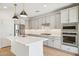 Modern kitchen with white cabinets, stainless steel appliances, and kitchen island at 6412 N 17Th Pl, Phoenix, AZ 85016